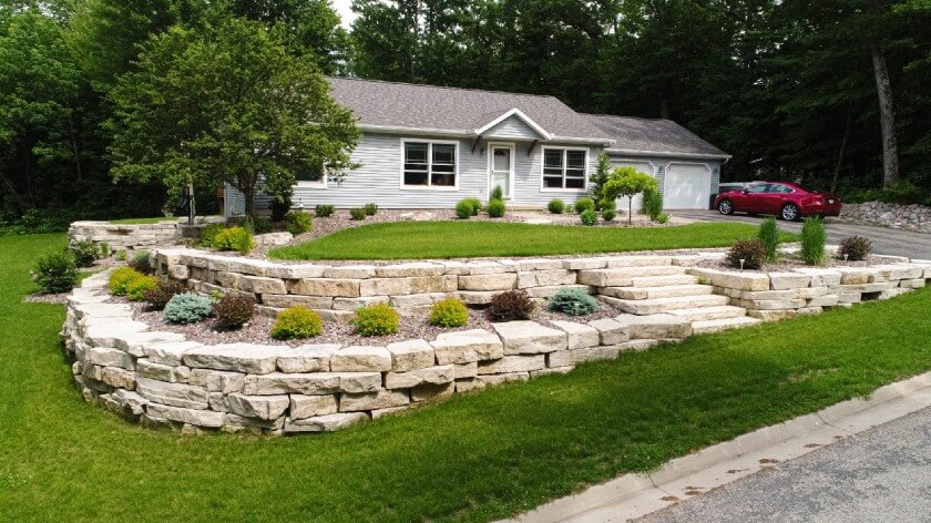 Curved paver walkway with foundation plantings and landscape design in Green Lake, WI