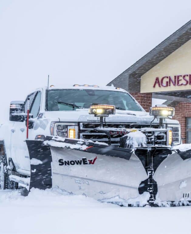 truck with snow plow outside business