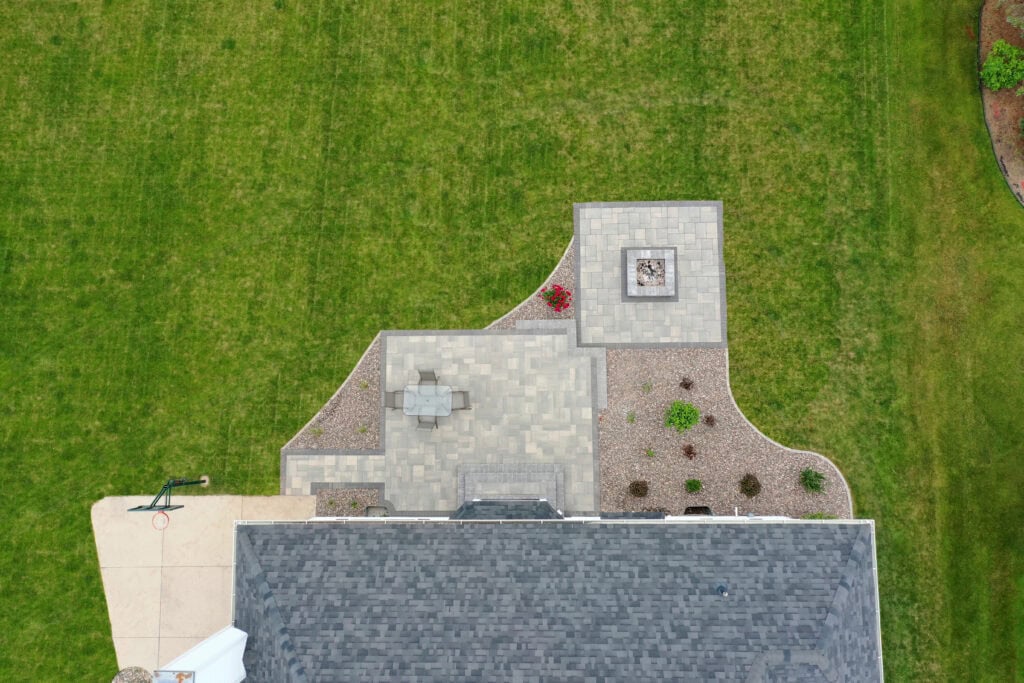 lawn care near me crew aerating and mowing a neighborhood lawn in West Bend, WI